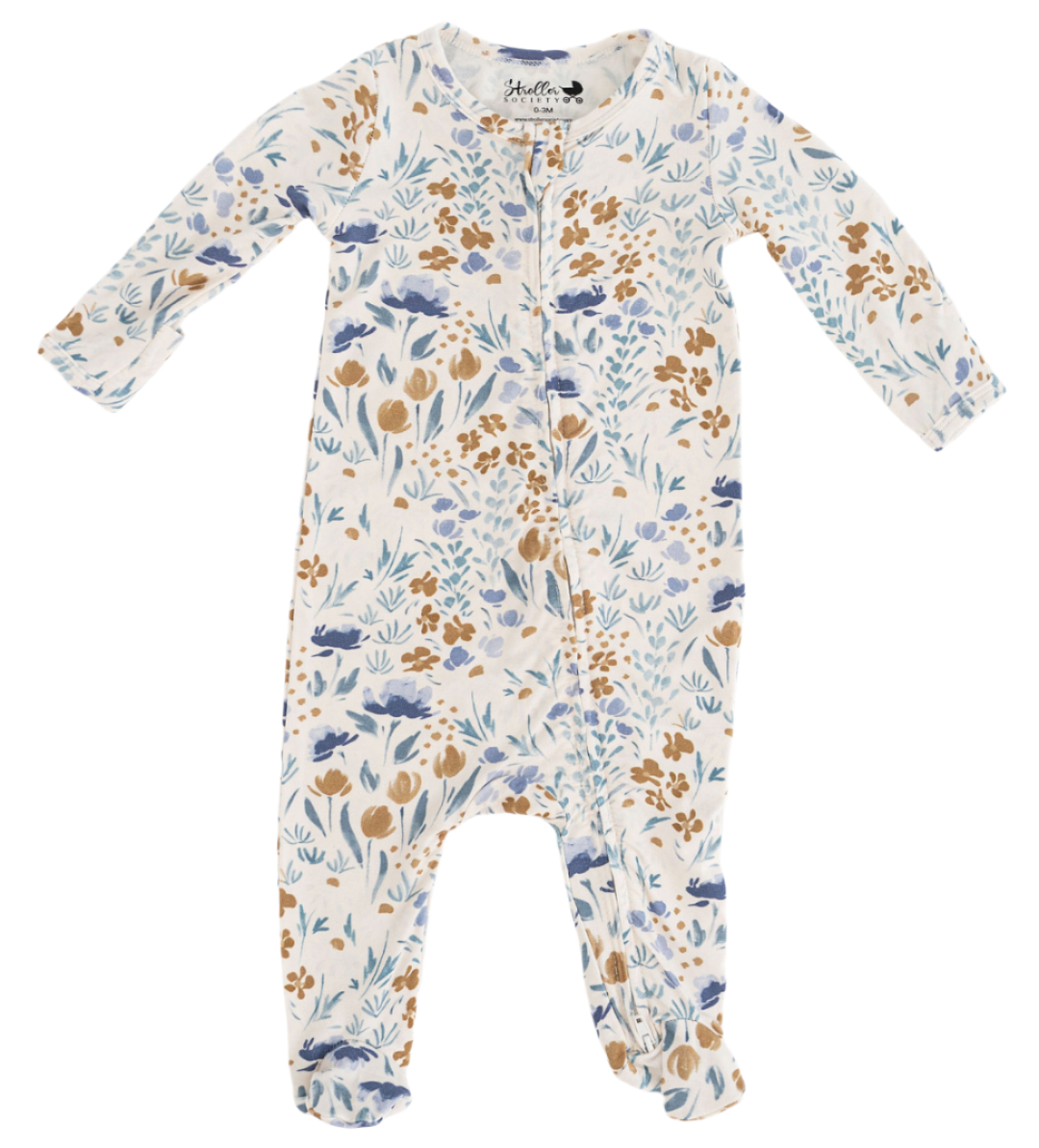 Floral patterned baby footed newborn onesie on a white background