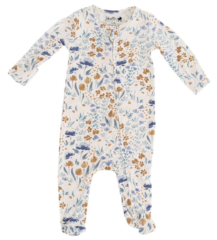 Floral patterned baby footed newborn onesie on a white background